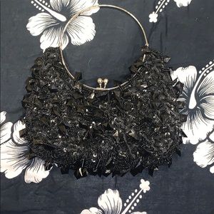 A black handbag with dangling rhinestones